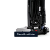 Close-up of the back of a upright vacuum cleaner showing a small red thermal reset button, with a dark overlay label reading 'Thermal Reset Button' on a white background.